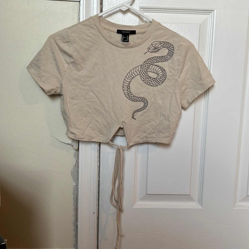 Crop top with serpent design and cut out in the middle